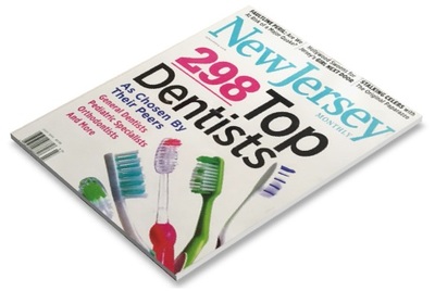 Magazine cover featuring "New Jersey 298 Top Dentists" with colorful toothbrushes displayed.
